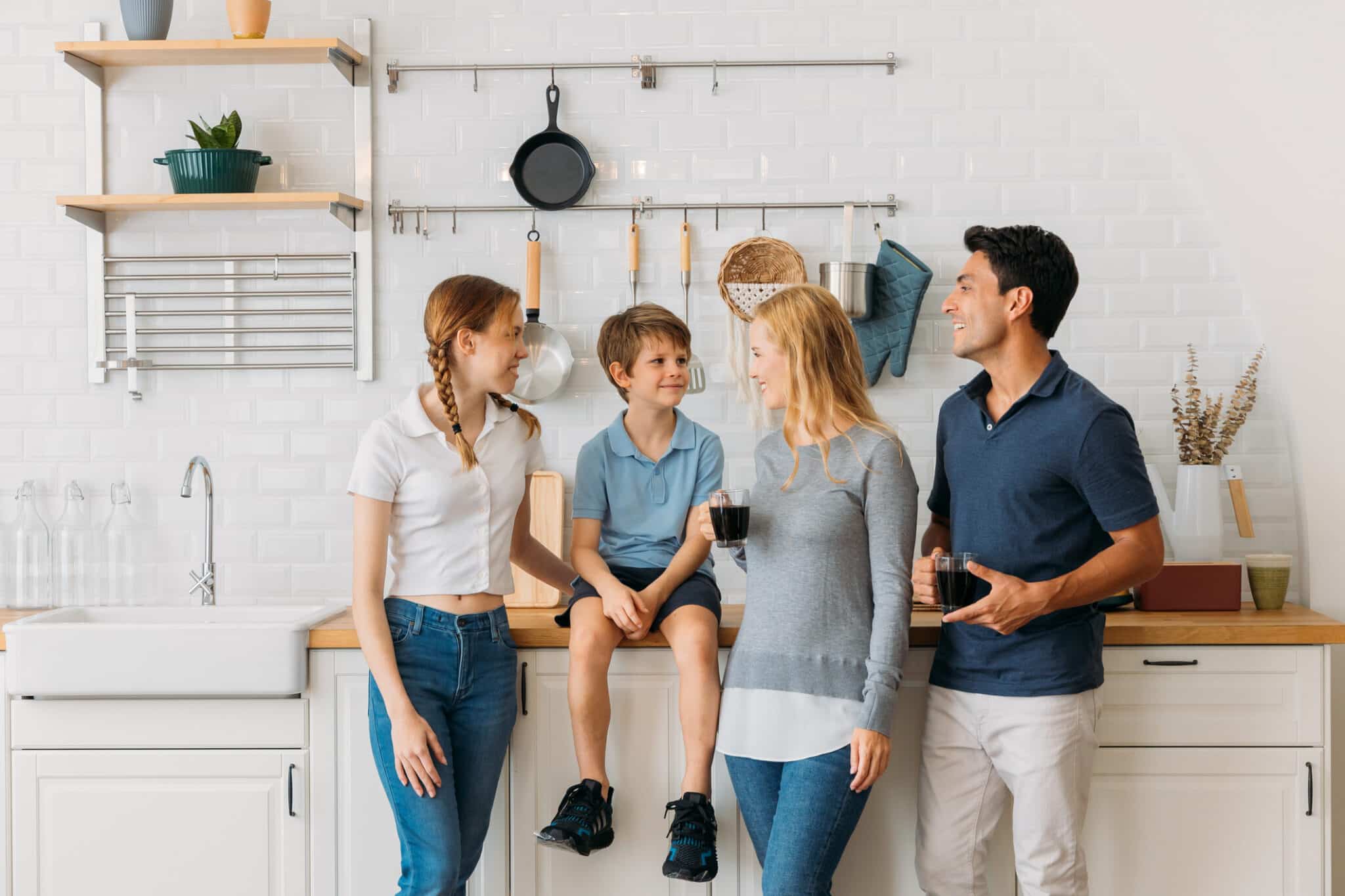 Happy family in modern kitchen, Regular Drain Cleaning.